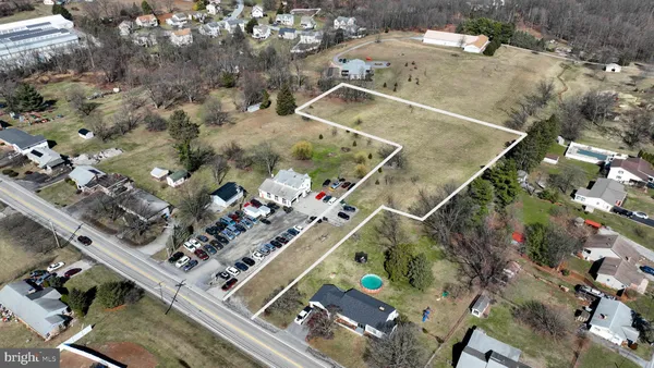 an aerial view of a residential houses with outdoor space