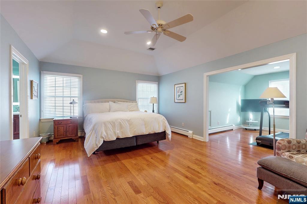 10 Hope Street Montvale, NJ 07645 - Photo 20 of 44 a spacious bedroom with a bed a dresser and wooden floor
