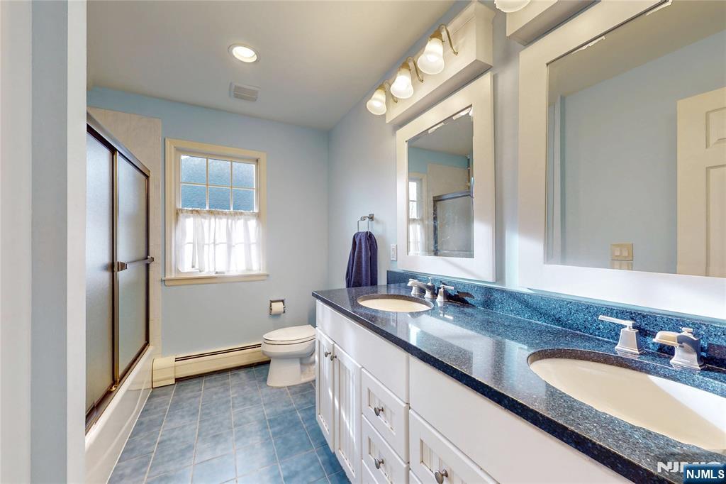 10 Hope Street Montvale, NJ 07645 - Photo 30 of 44 a bathroom with a granite countertop double vanity sink a mirror and a toilet