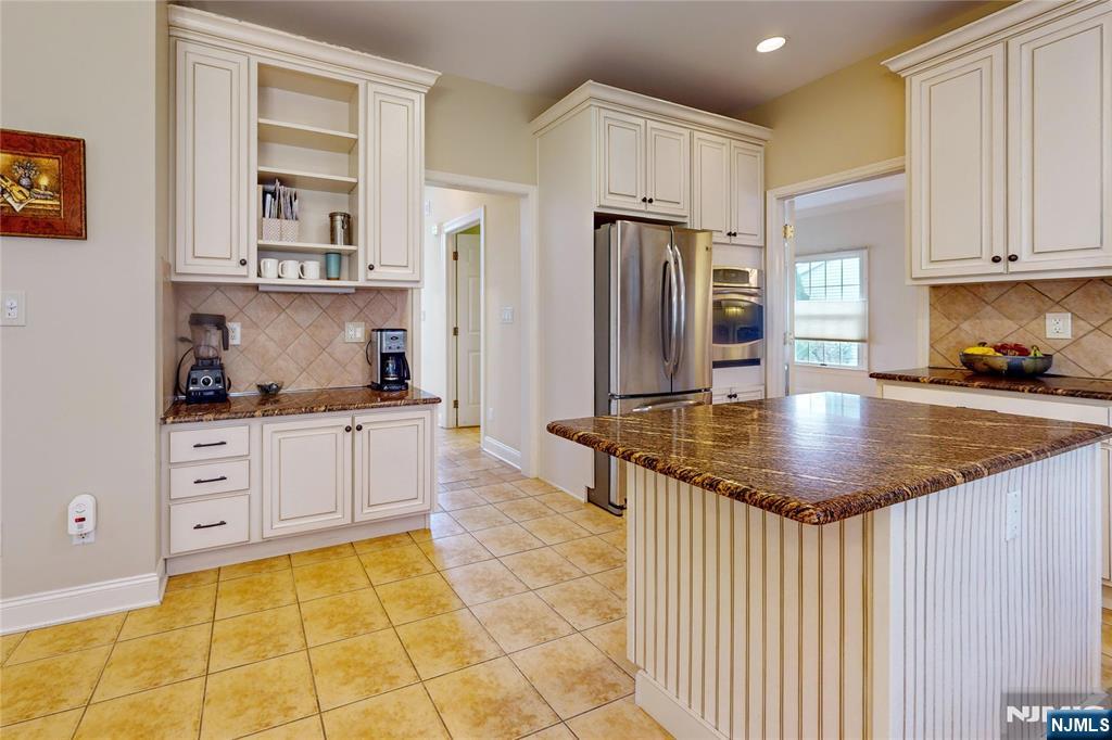 10 Hope Street Montvale, NJ 07645 - Photo 6 of 44 a kitchen with stainless steel appliances granite countertop a sink a stove a refrigerator and cabinets