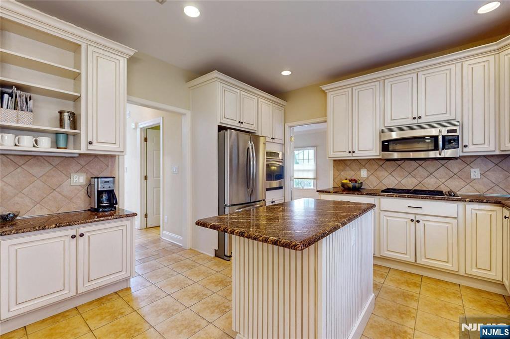10 Hope Street Montvale, NJ 07645 - Photo 7 of 44 a kitchen with stainless steel appliances granite countertop a stove a sink a refrigerator and white cabinets