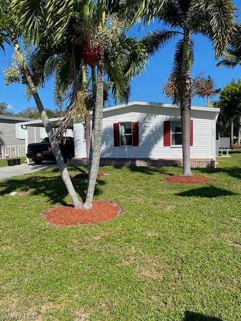 222 Riverwood Road Naples, FL 34114 - Photo 1 of 23 a front view of a house with garden