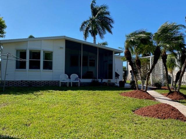 222 Riverwood Road Naples, FL 34114 - Photo 19 of 23 front view of a house with a yard