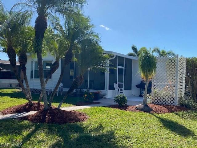 222 Riverwood Road Naples, FL 34114 - Photo 20 of 23 a backyard of a house with lots of green space