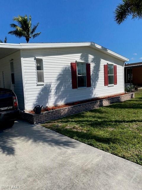 222 Riverwood Road Naples, FL 34114 - Photo 2 of 23 a front view of house with a yard