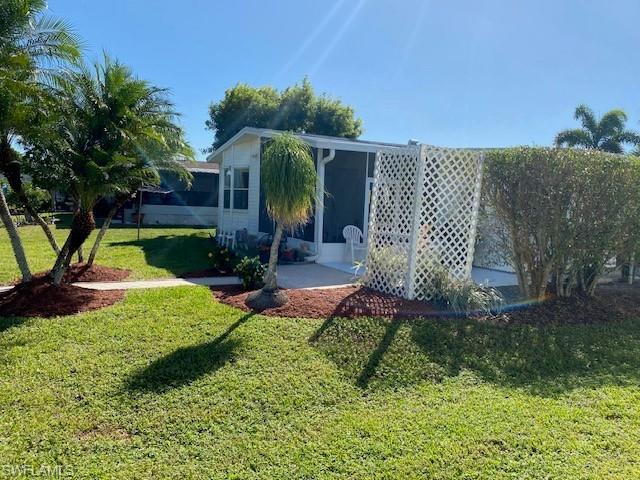 222 Riverwood Road Naples, FL 34114 - Photo 21 of 23 a front view of a house with garden