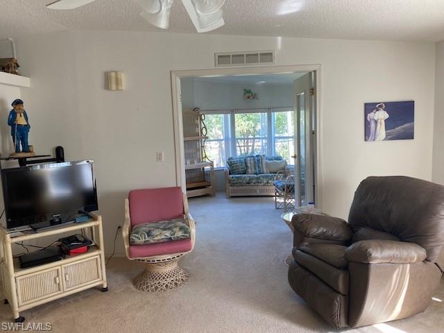 222 Riverwood Road Naples, FL 34114 - Photo 3 of 23 a living room with furniture and a flat screen tv