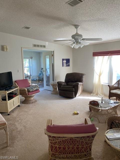 222 Riverwood Road Naples, FL 34114 - Photo 5 of 23 a living room with furniture and a chandelier