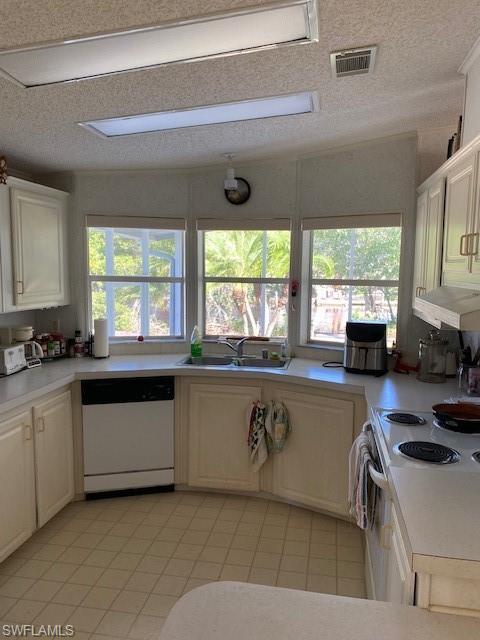 222 Riverwood Road Naples, FL 34114 - Photo 8 of 23 a kitchen with a stove a sink and a microwave