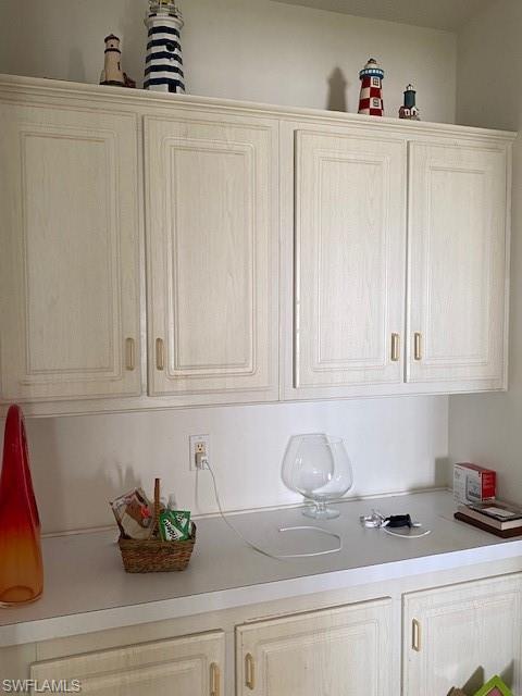 222 Riverwood Road Naples, FL 34114 - Photo 10 of 23 a kitchen with stainless steel appliances granite countertop white cabinets sink and cabinets