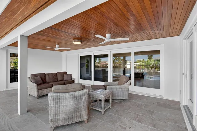 a living room with furniture and a ceiling fan