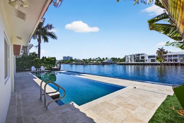 a view of a swimming pool and lounge chairs