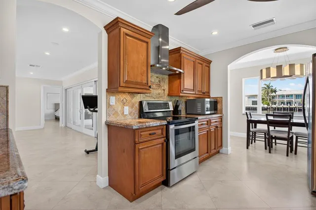 a kitchen with stainless steel appliances granite countertop a stove and a refrigerator
