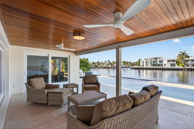 a living room with furniture and a floor to ceiling window