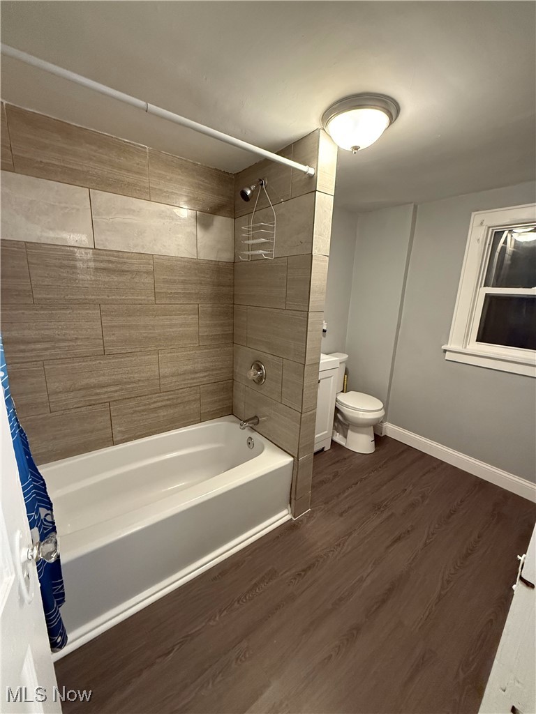 1013 Berwin Street Akron, OH 44310 - Photo 10 of 13 Bathroom with toilet, shower / bath combination with curtain, and hardwood / wood-style flooring