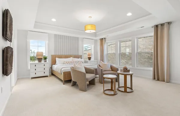 a spacious bedroom with a bed and large windows