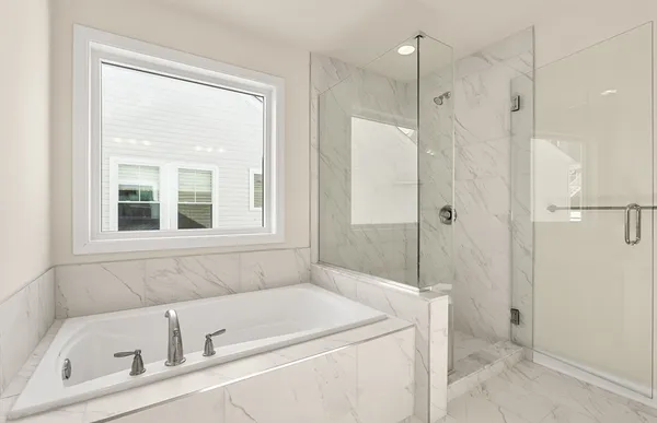 a bathroom with a tub shower and sink