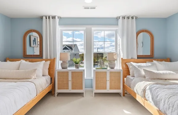 a spacious bedroom with a bed and a large window