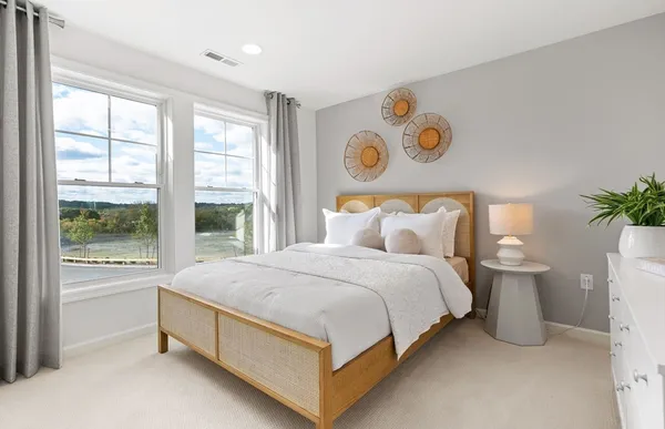 a bedroom with a bed and glass walk in closet