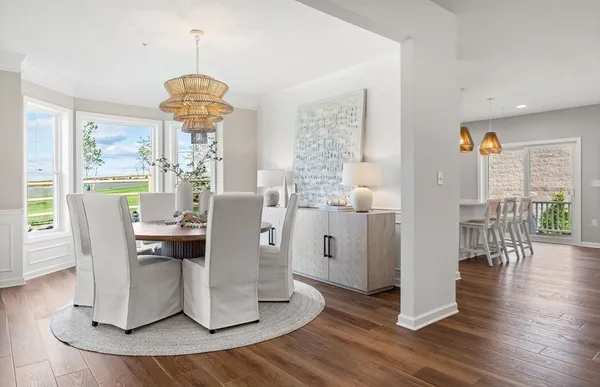 a view of a dining room with furniture window and wooden floor