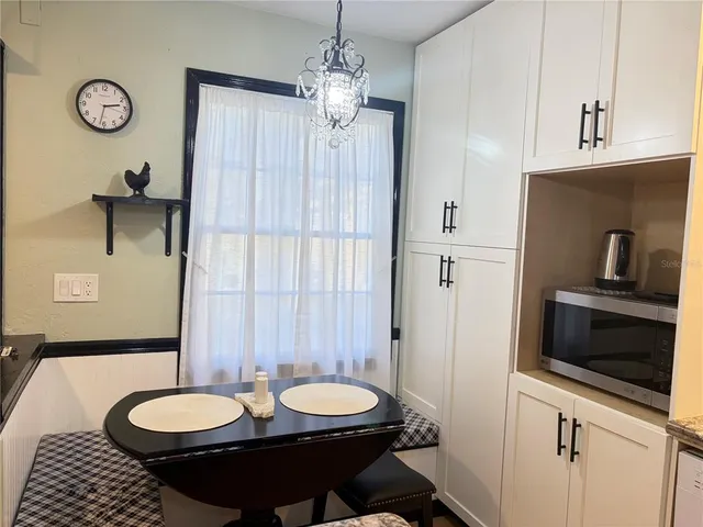 a bathroom with a granite countertop sink a mirror and a toilet
