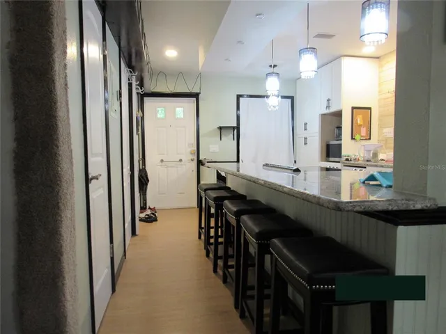 a kitchen with sink and refrigerator