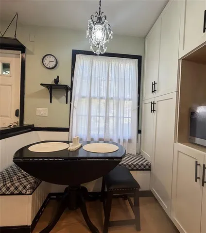 a dining room with furniture and window