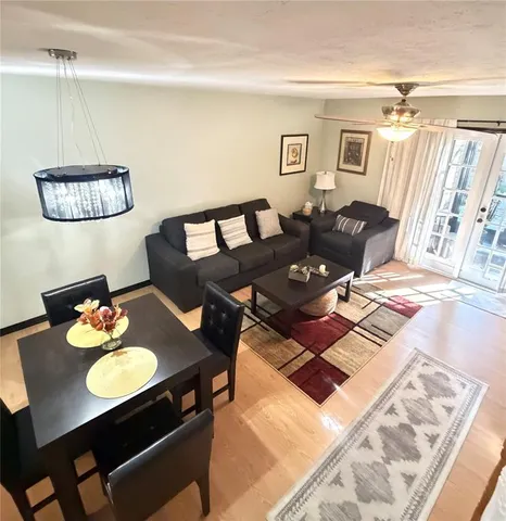 a living room with furniture and wooden floor