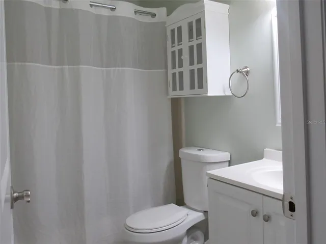 a white toilet sitting next to a bathroom sink