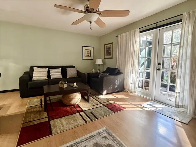 a living room with furniture a rug and a window
