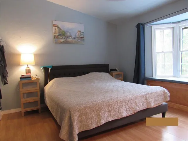 a bedroom with a bed and window