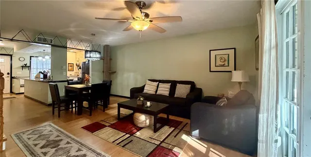 a living room with furniture and a chandelier