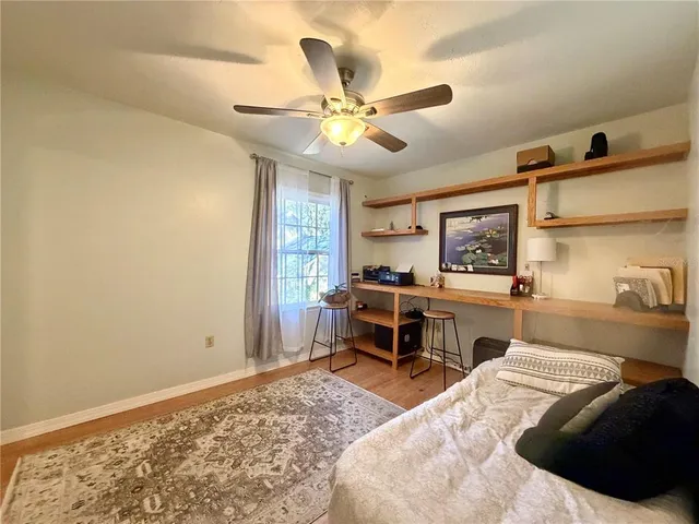 a bedroom with a bed and a desk