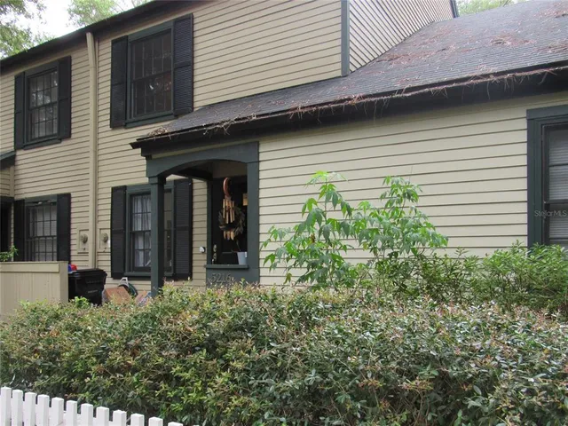 a view of a house with potted plants
