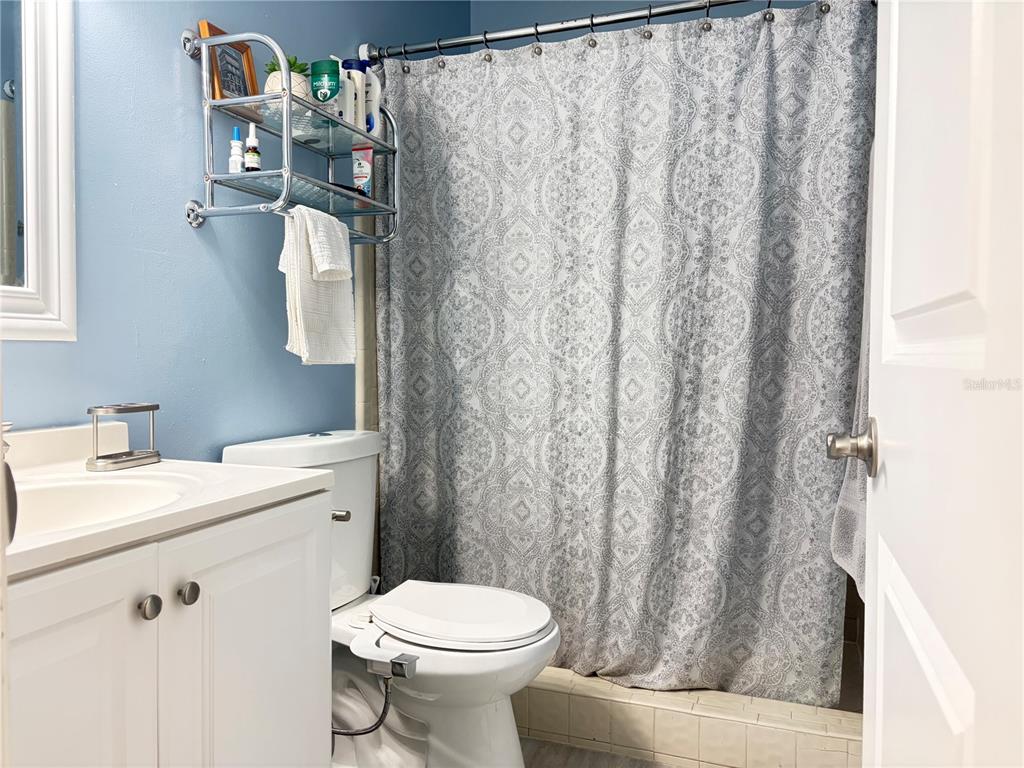 5216 Southwest 92nd Court Gainesville, FL 32608 - Photo 27 of 32 a bathroom with a sink a toilet and shower curtain