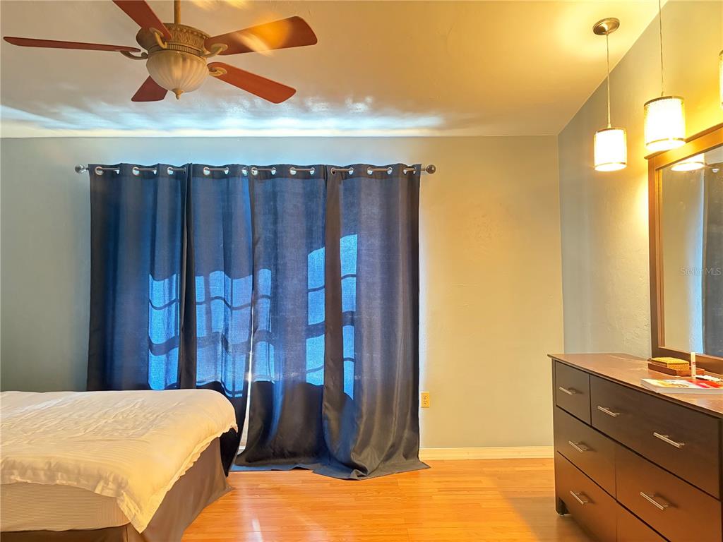 5216 Southwest 92nd Court Gainesville, FL 32608 - Photo 28 of 32 a bedroom with a bed and a dresser