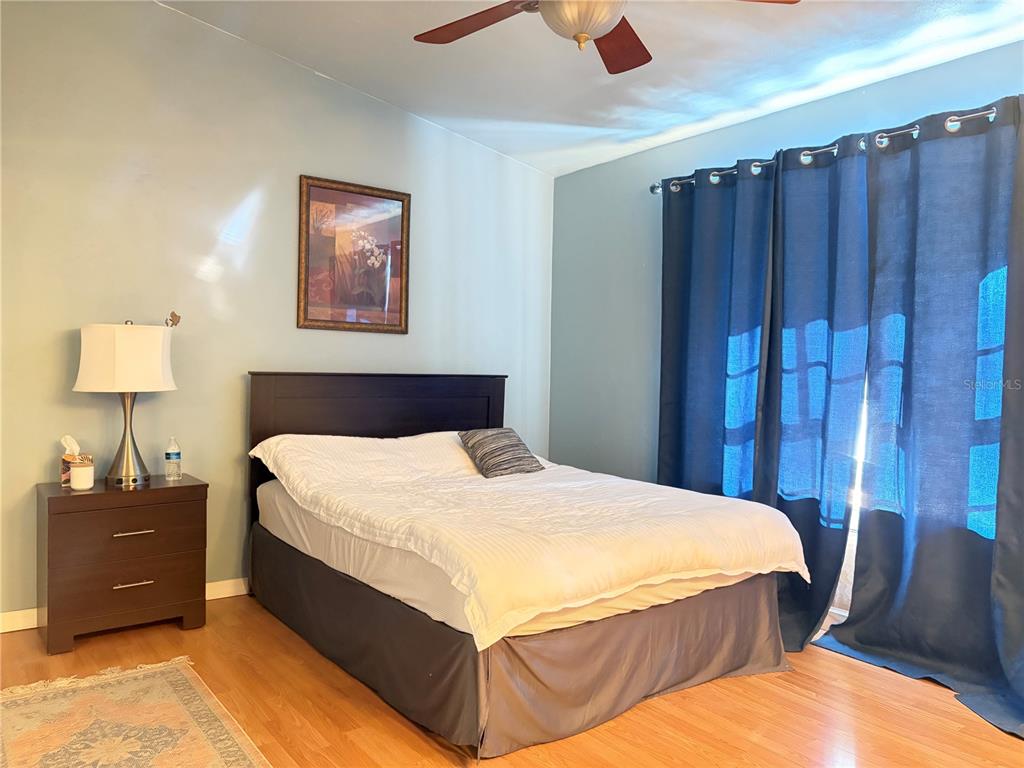 5216 Southwest 92nd Court Gainesville, FL 32608 - Photo 29 of 32 a bedroom with bed and wooden floor