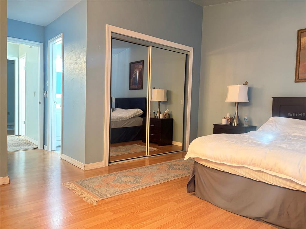 5216 Southwest 92nd Court Gainesville, FL 32608 - Photo 30 of 32 a room with a bed and a mirror