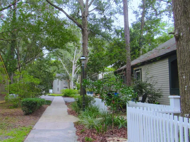 a front view of a house with a yard and fountain
