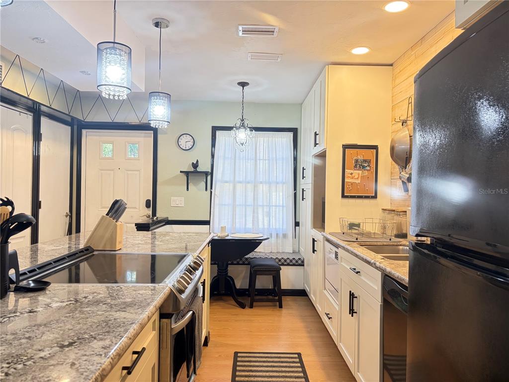 5216 Southwest 92nd Court Gainesville, FL 32608 - Photo 8 of 32 a bathroom with a granite countertop sink a toilet a mirror and shower