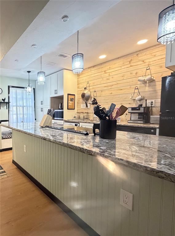 5216 Southwest 92nd Court Gainesville, FL 32608 - Photo 9 of 32 a view of a kitchen with kitchen island a large counter top space a sink stainless steel appliances and cabinets