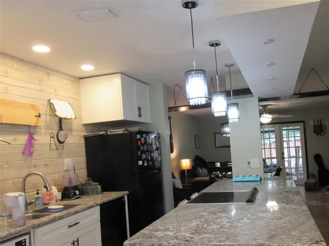 a kitchen with sink and refrigerator