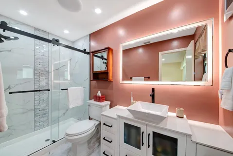 a bathroom with a sink toilet and shower