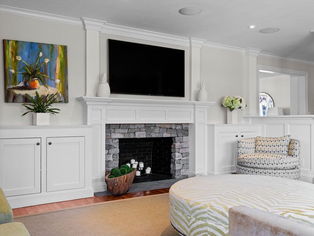 15 Barnstable Road Wellesley, MA 02481 - Photo 10 of 24 a bedroom with a bed a fireplace and a flat screen tv