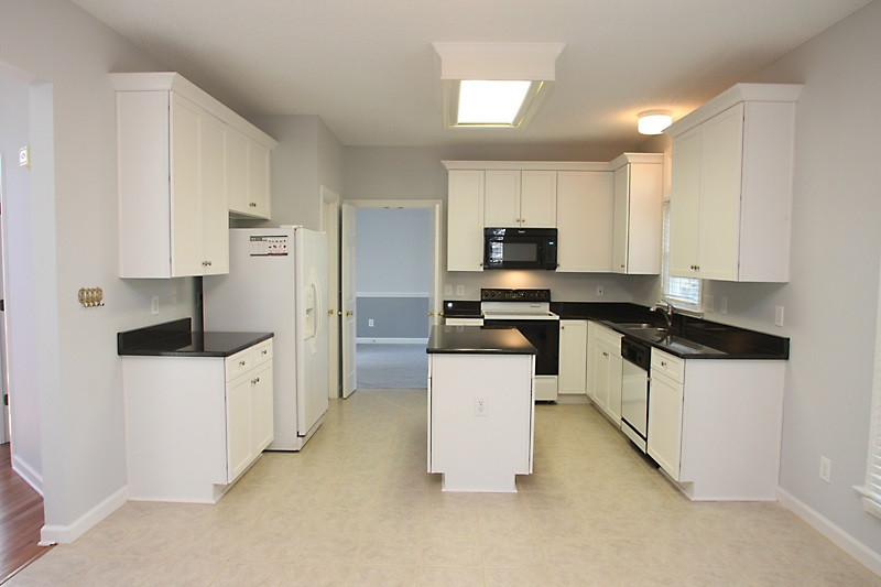 9021 Breeland Way Raleigh, NC 27613 - Photo 7 of 20 New beautiful kitchen. All cabinets have soft close drawers and gleaming new granite! Spectacular center island for food prep or hang out area! New microwave, smooth top stove! Kitchen