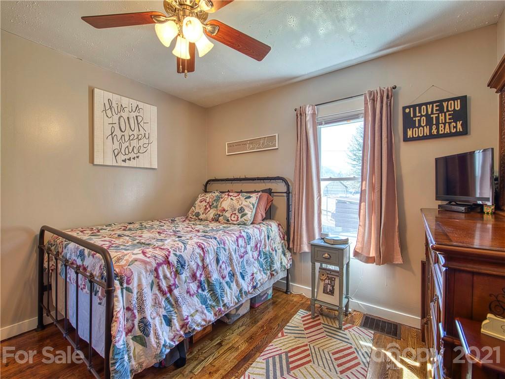 337 Possum Ridge Road Canton, NC 28716 - Photo 14 of 24 a bedroom with a bed and a flat screen tv
