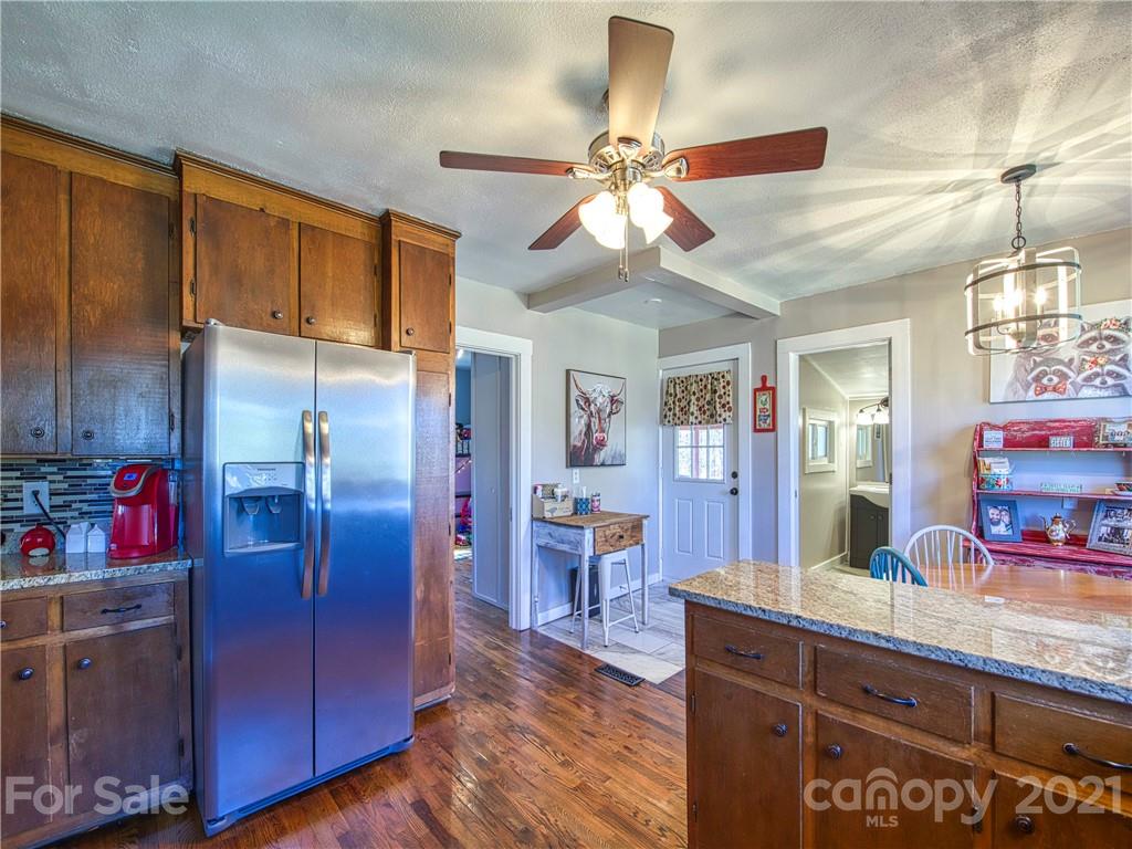 337 Possum Ridge Road Canton, NC 28716 - Photo 22 of 24 a kitchen with cabinets a center island and stainless steel appliances