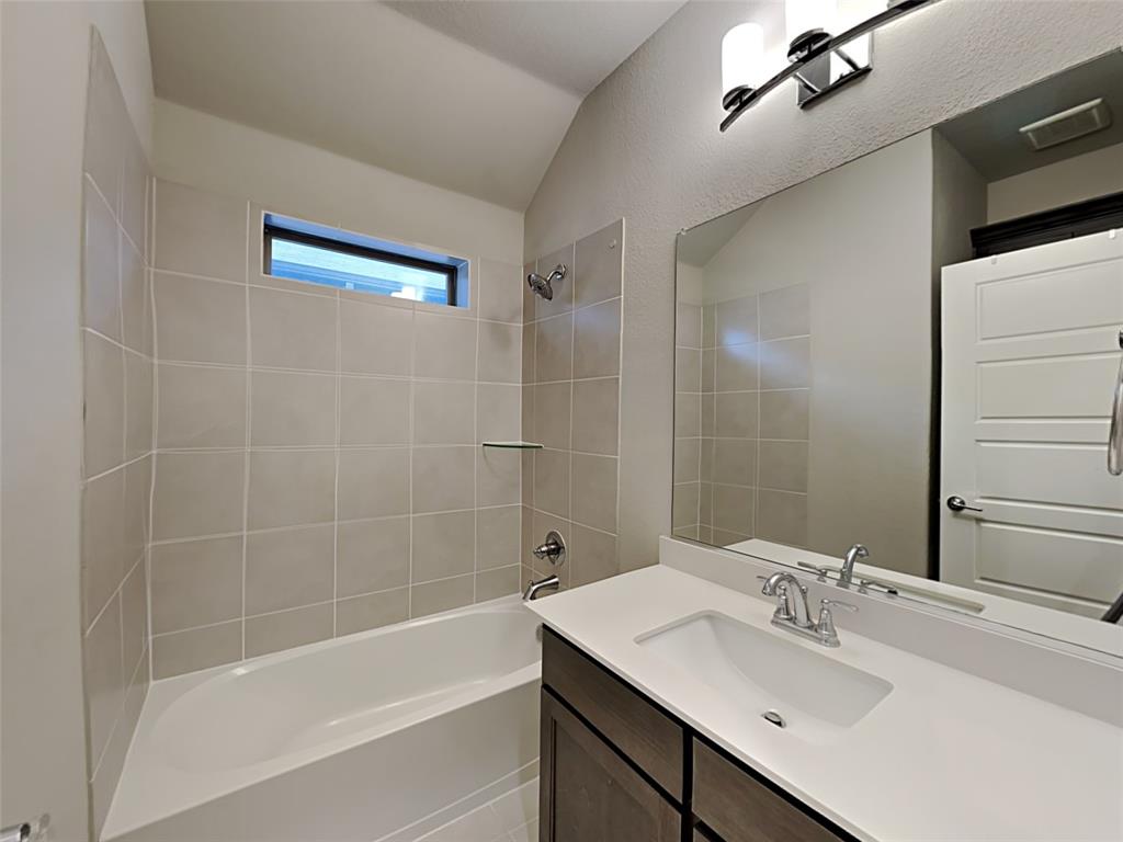 8262 Ottowa Ridge Frisco, TX 75034 - Photo 17 of 24 a bathroom with a bathtub shower sink vanity and a mirror