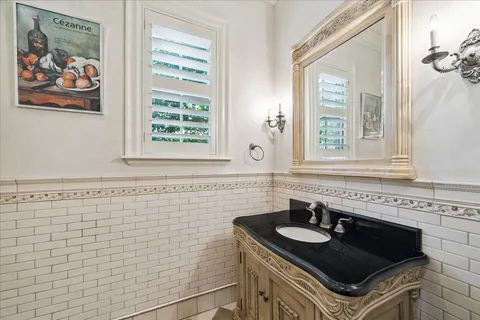 a bathroom with a sink a vanity and a window
