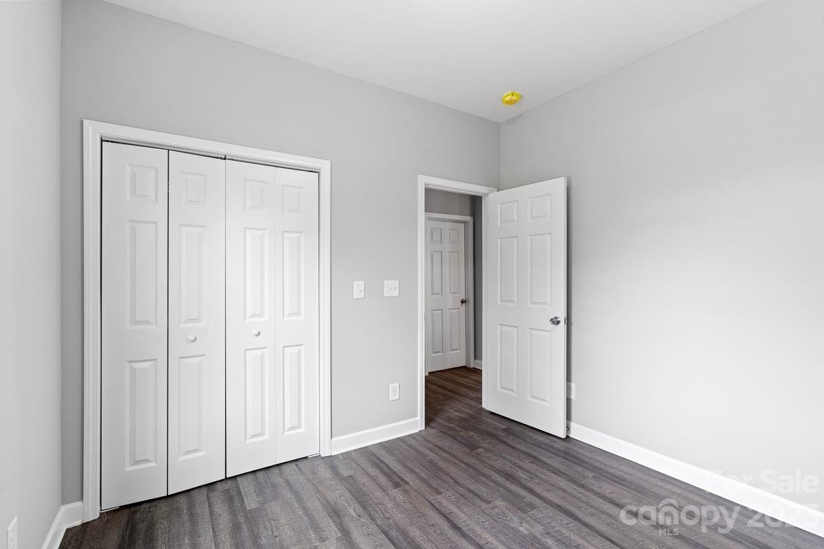 422 Queens Road Gastonia, NC 28052 - Photo 11 of 18 a view of an empty room with closet and wooden floor